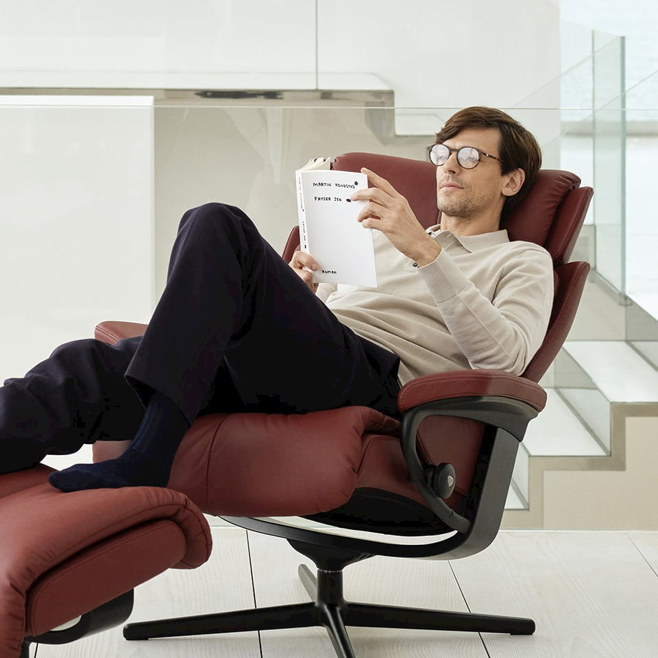 Man reading a book in a Stressless® Magic