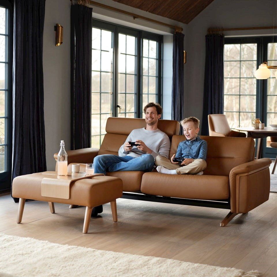 Father and son gaming in Stressless Stella sofa