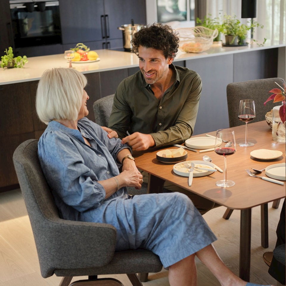 Mother and son talking by Stressless dining table