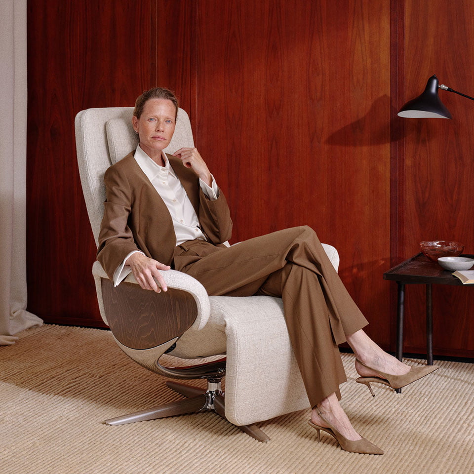 Woman sitting in Stressless Helsinki recliner