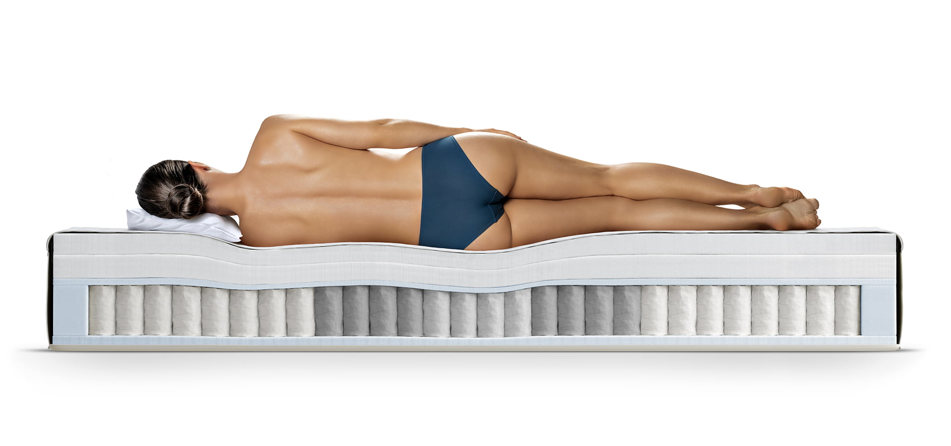 Woman laying on a cutout Stressless mattress