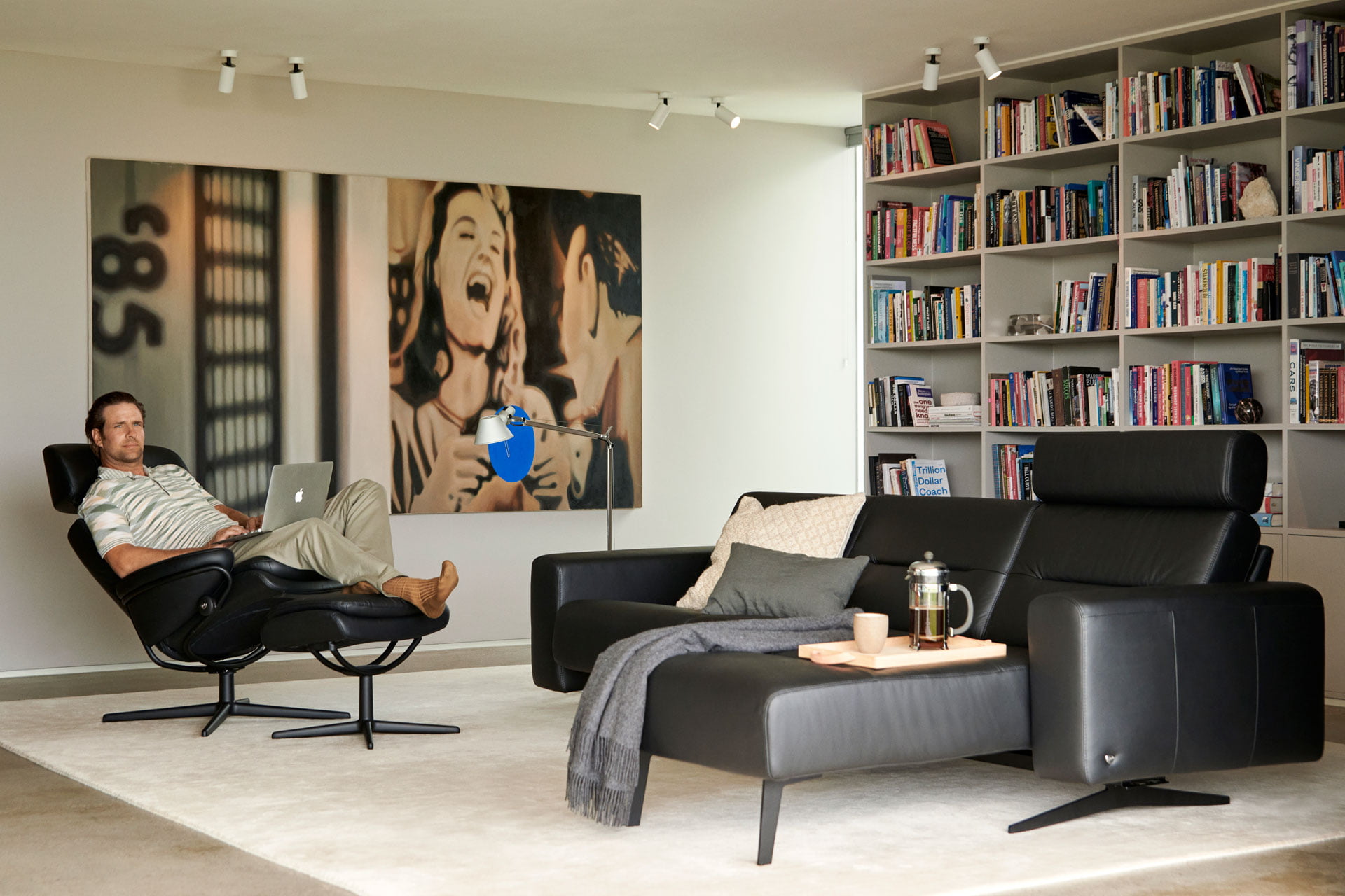 Man sitting in Stressless Romerecliner by Stella sofa
