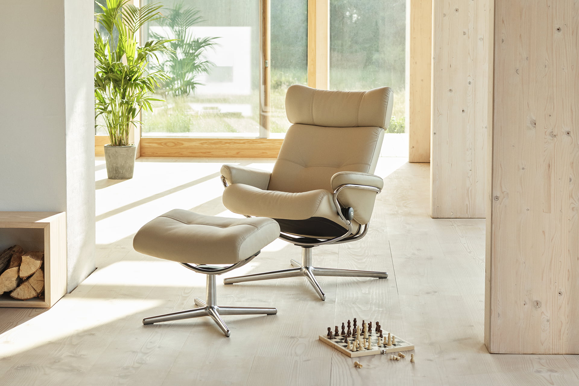 A stressless recliner with a footstool in a living room