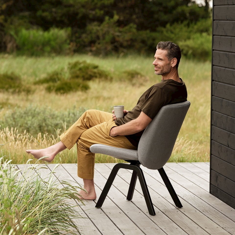Man relaxing on veranda in a Stressless dining chair