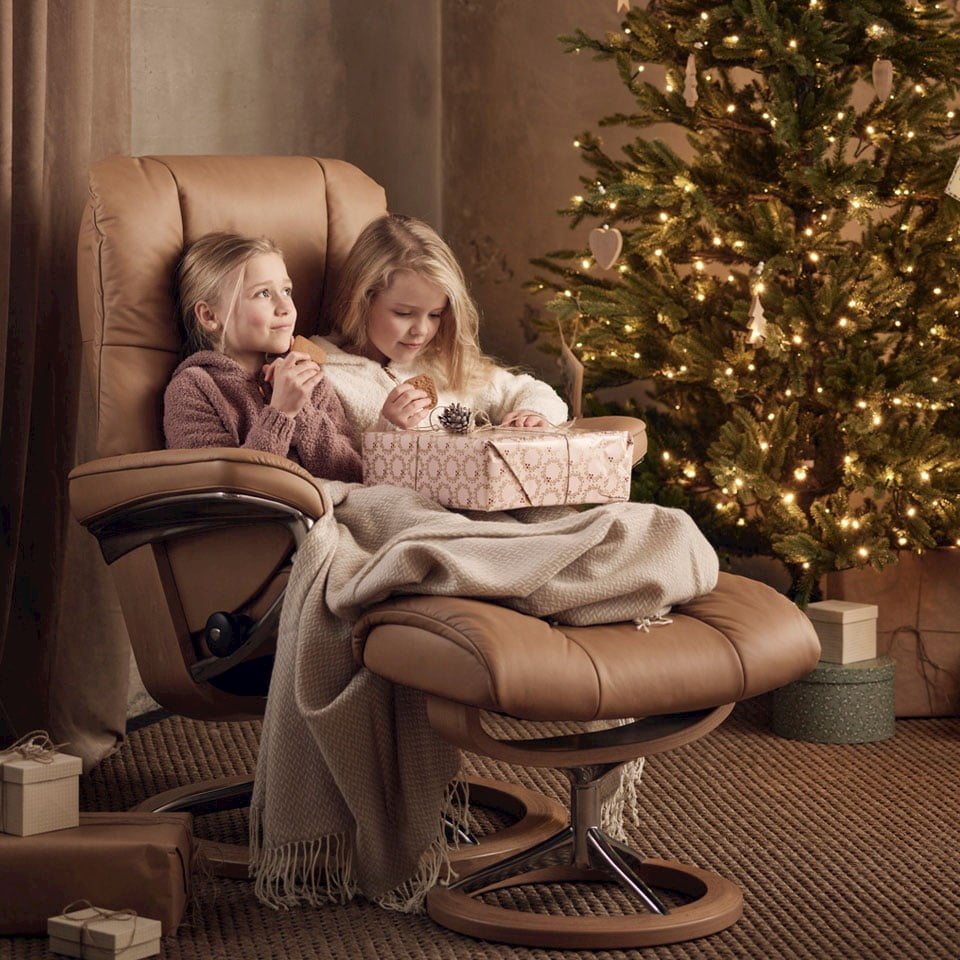 Girls in Stressless Mayfair recliner by Christmas tree