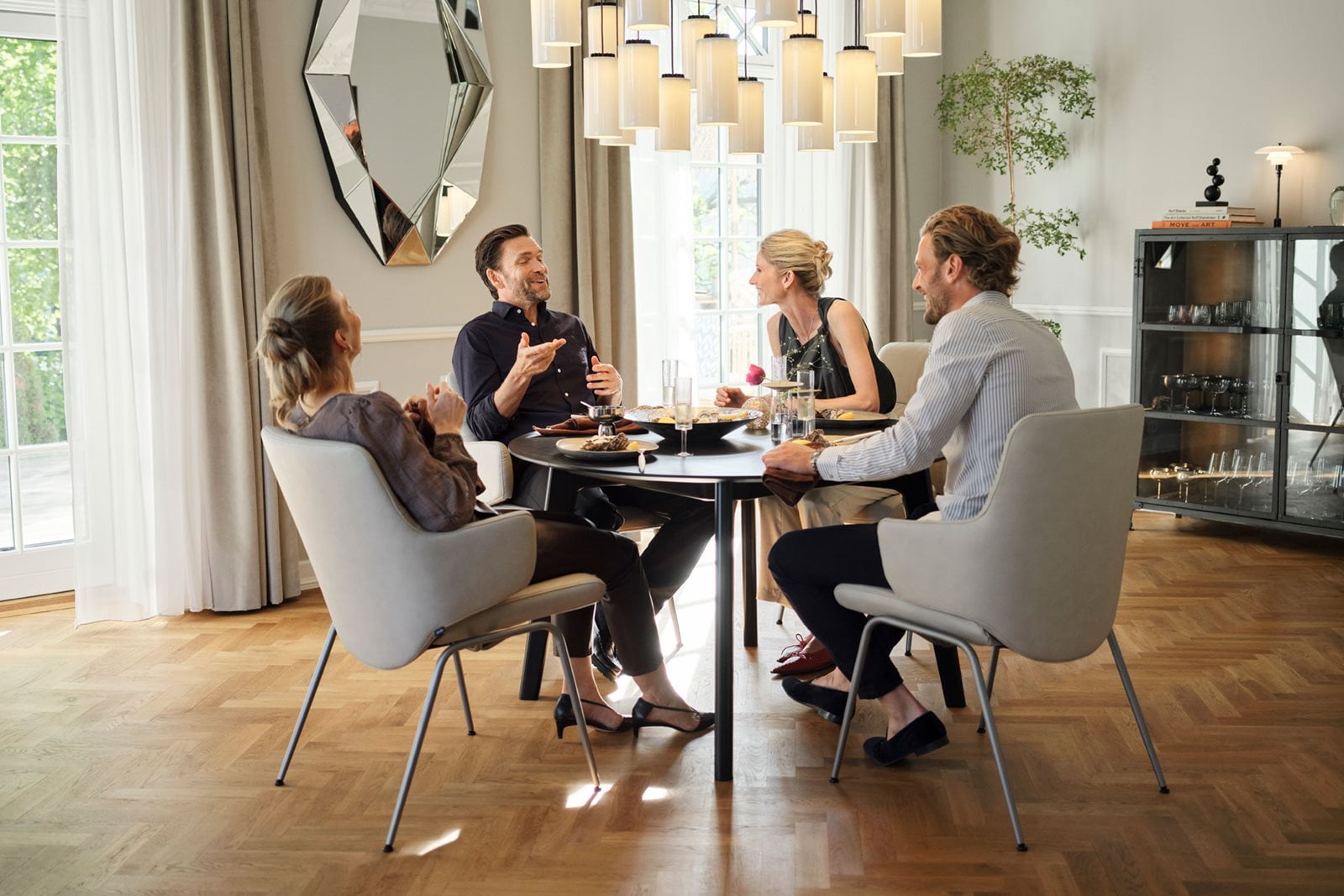Friends having a good time sitting at Stressless Mint dining chairs.