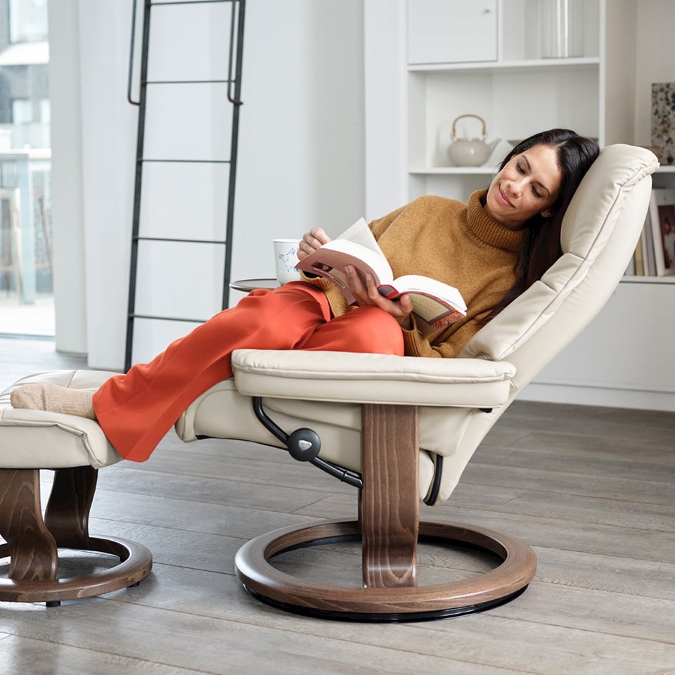 Woman reading in a recliner with her feet resting on the ottoman