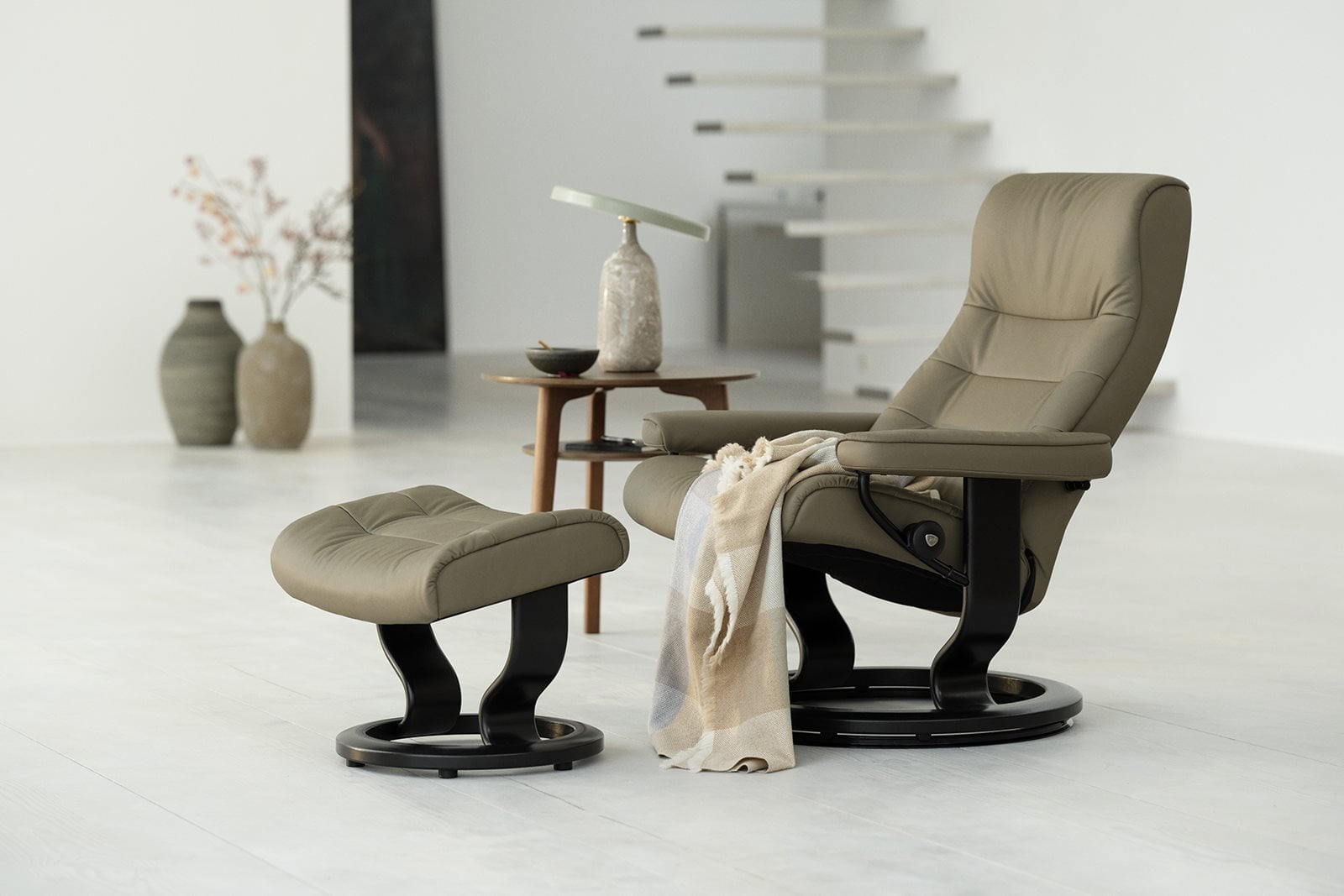 An olive green Stressless® Opal in a modern light room