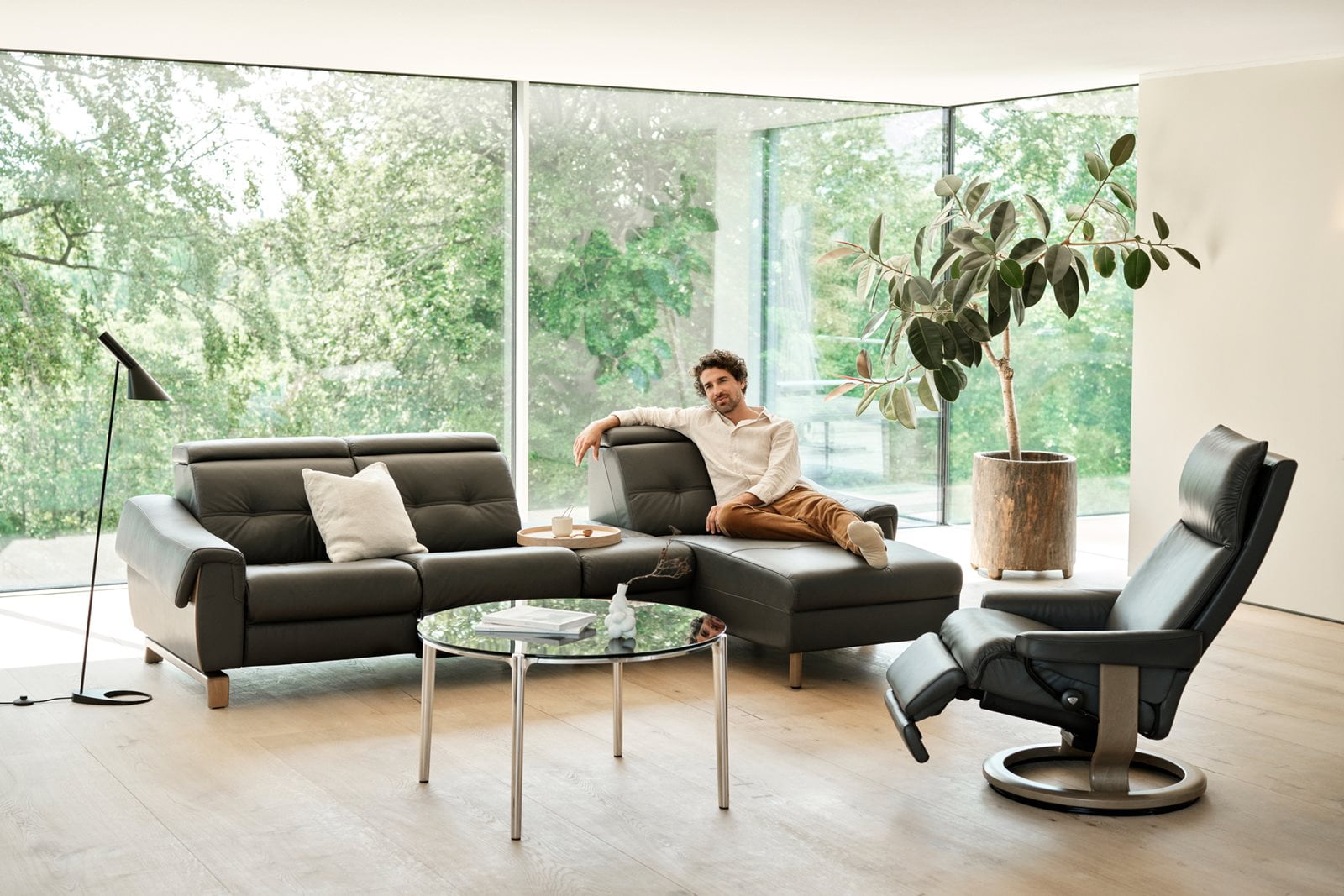A man sitting in a sofa in a living room